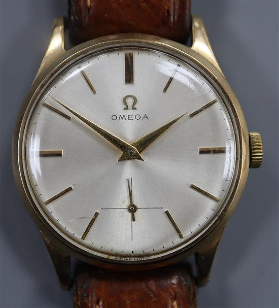 A gentlemans 1950s 9ct gold Omega manual wind wrist watch, on leather strap with Omega buckle, movement c.266.
